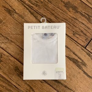 2 sleeveless bodysuits in white. 6m